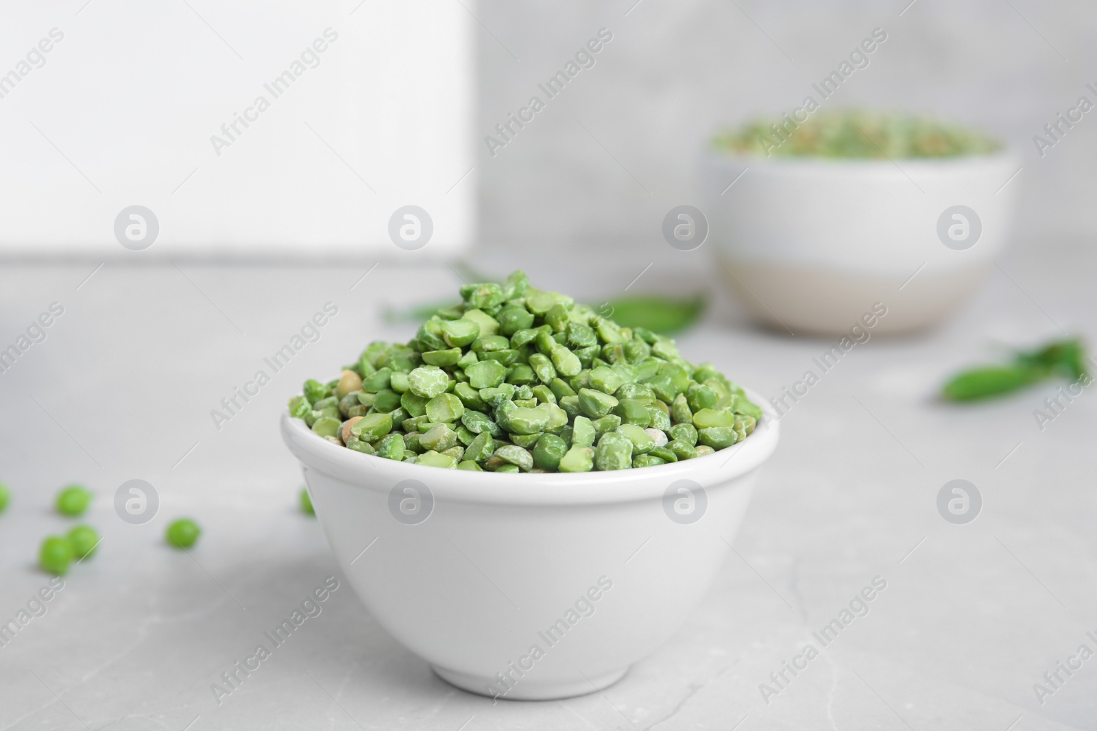 Photo of Ceramic bowl with dried peas on table