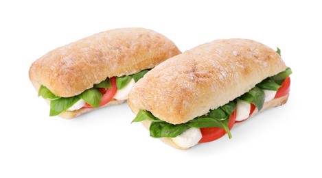 Delicious Caprese sandwiches with mozzarella, tomatoes and basil isolated on white