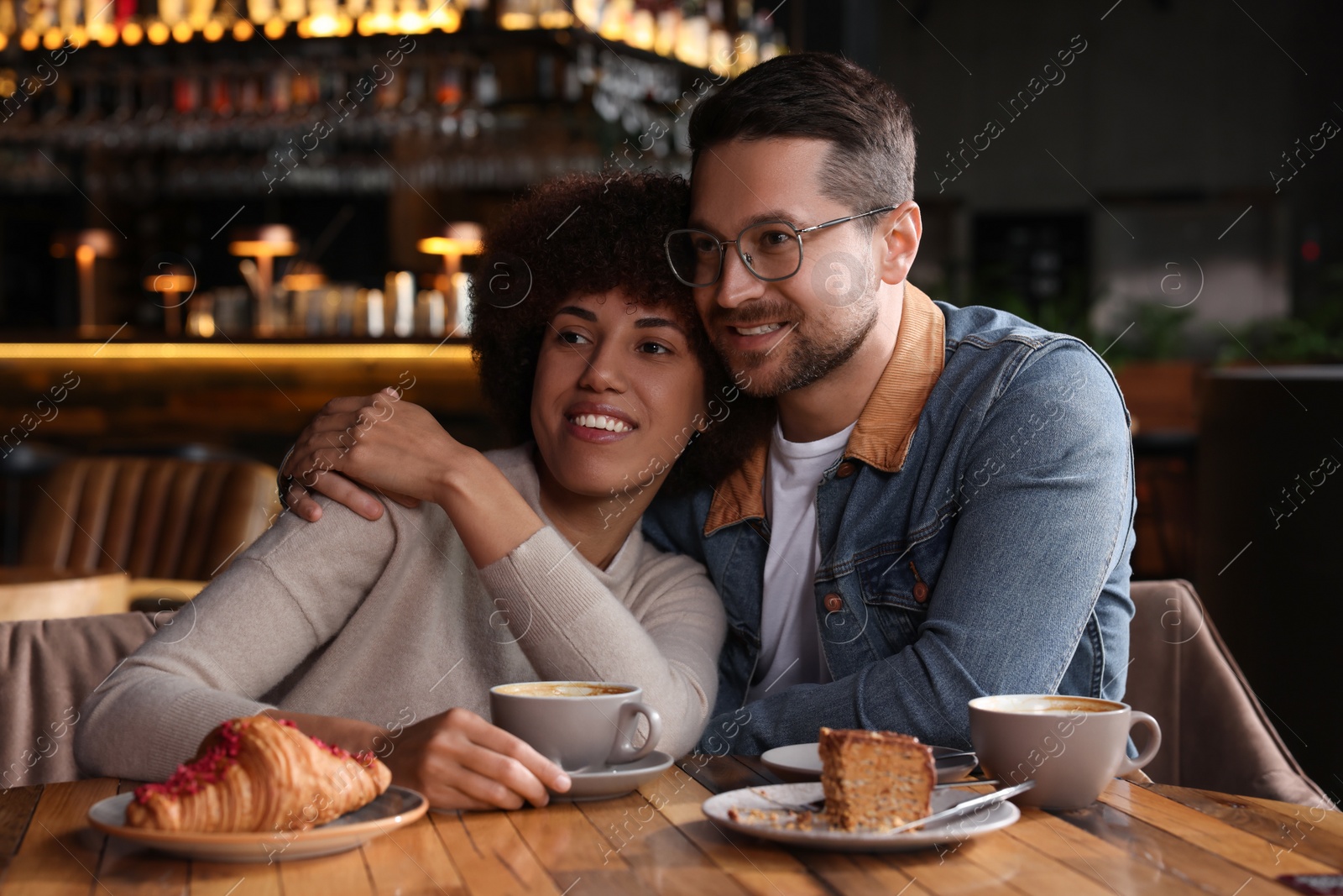 Photo of International relationships. Lovely couple having romantic date in cafe