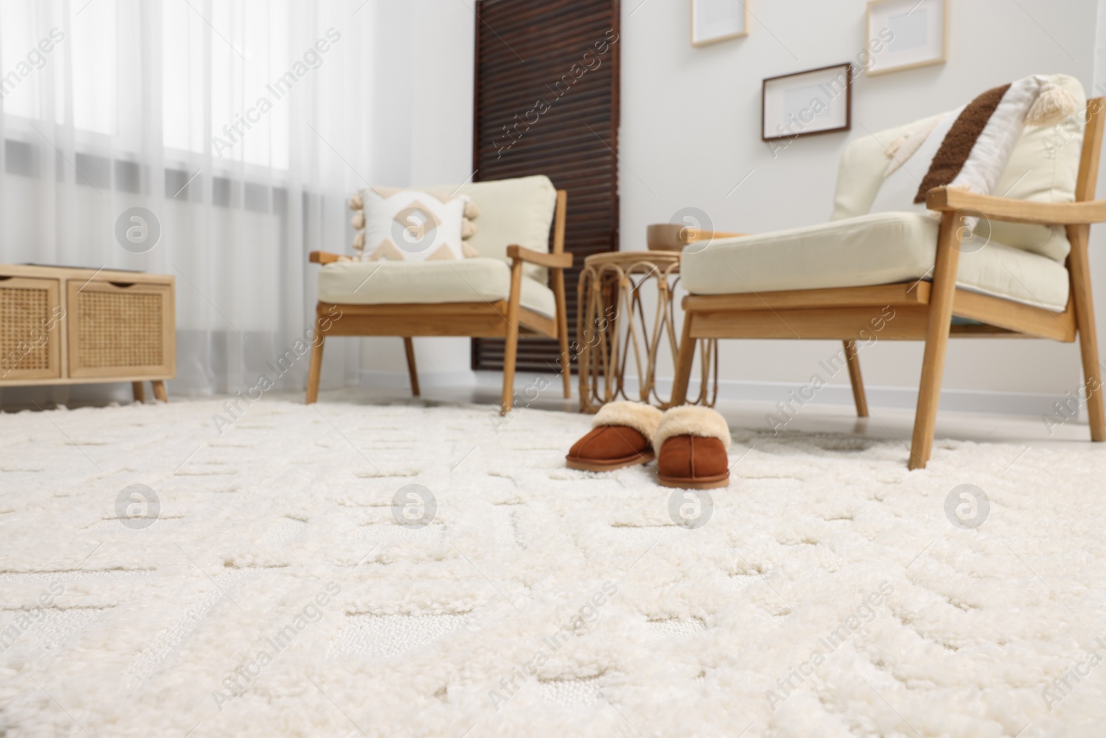 Photo of Stylish living room with soft white carpet and furniture, low angle view. Interior design