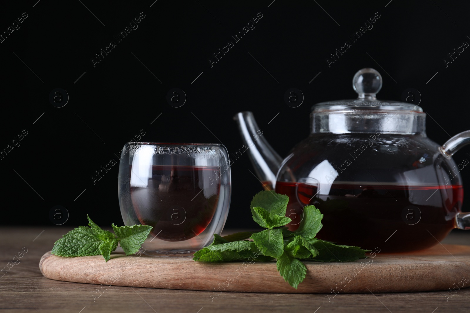 Photo of Fresh tea with mint leaves on wooden table