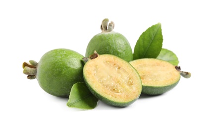 Photo of Whole and cut feijoa fruits on white background