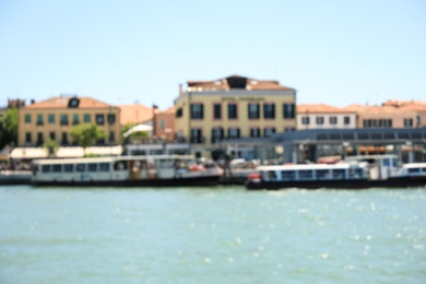 VENICE, ITALY - JUNE 13, 2019: Blurred view of city on sea shore