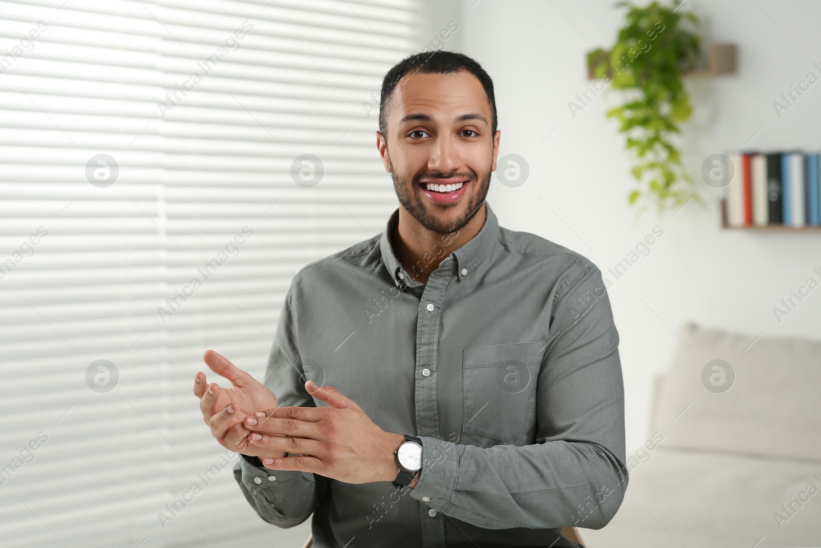 Photo of Young man having online video call at home, view from camera