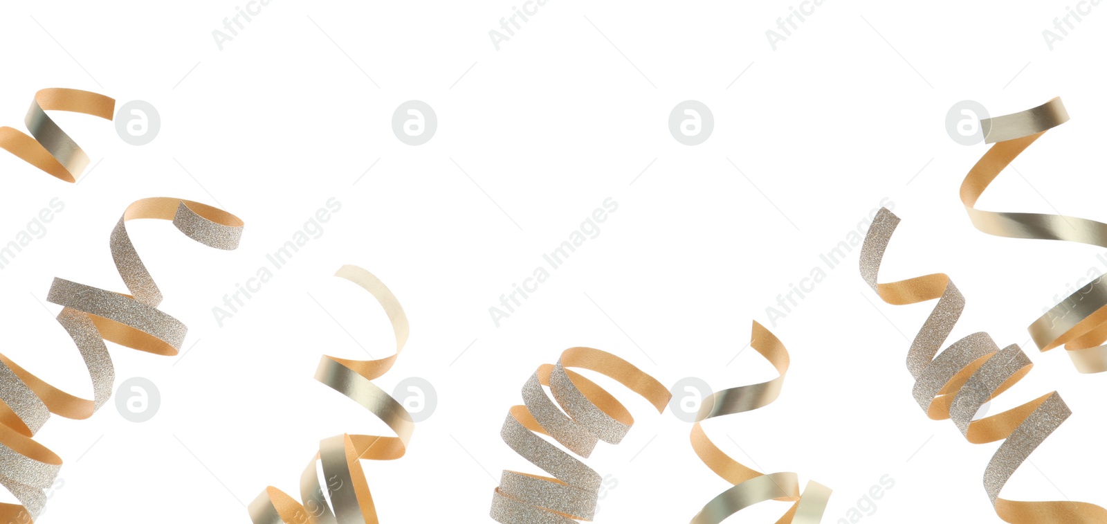 Photo of Shiny serpentine streamers on white background. Festive decor