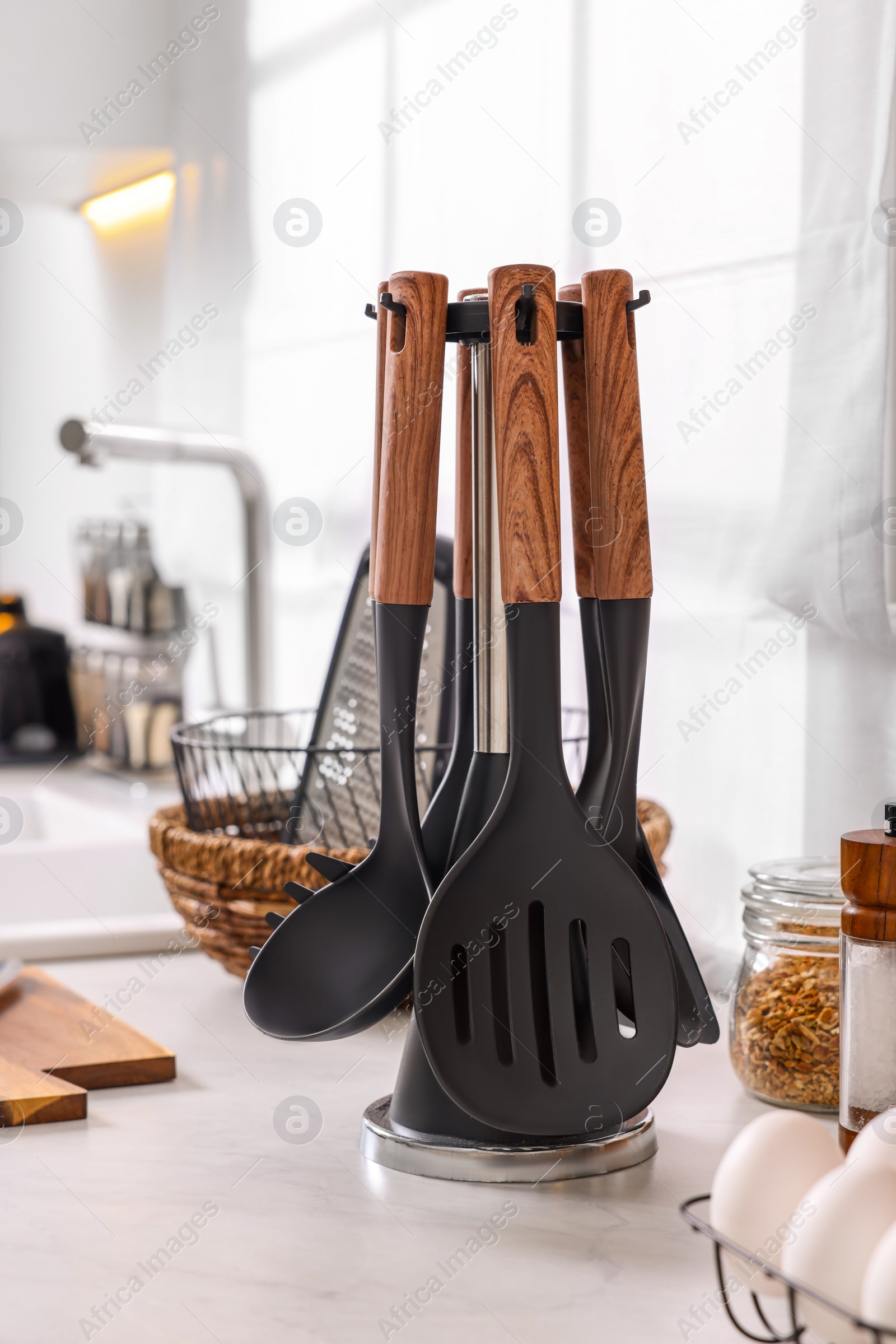 Photo of Set of different utensils on countertop in kitchen