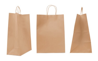 Image of Set with kraft paper bags on white background