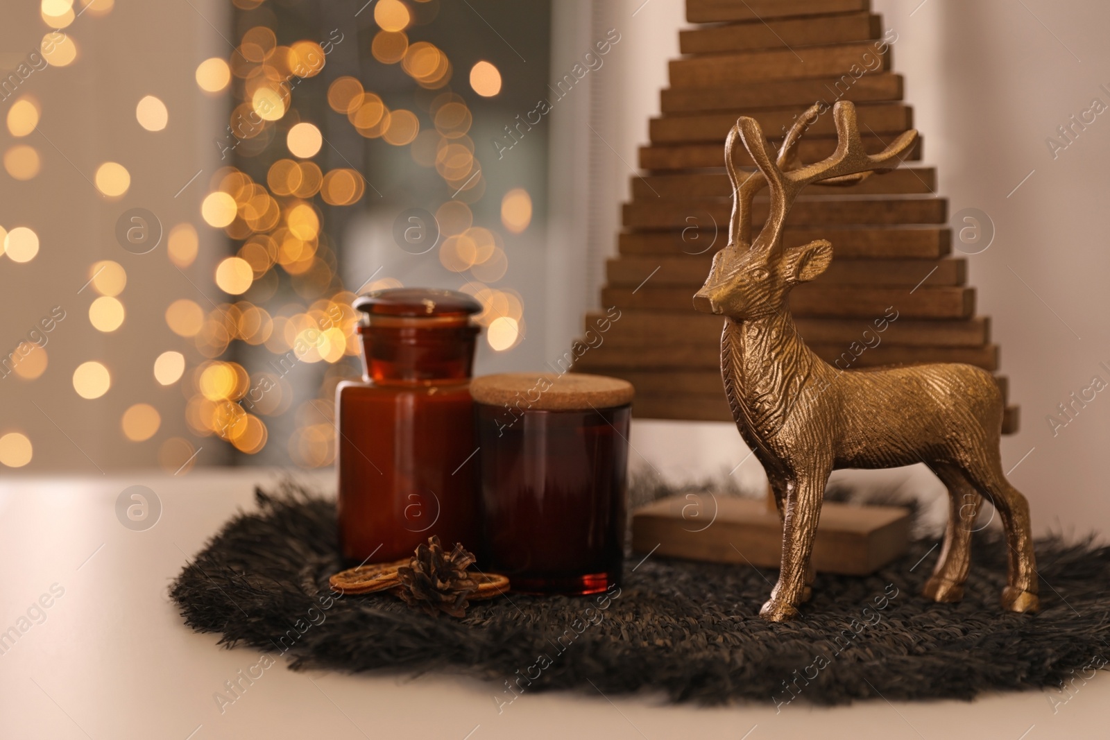 Photo of Composition with decorative Christmas tree and reindeer on light table, closeup