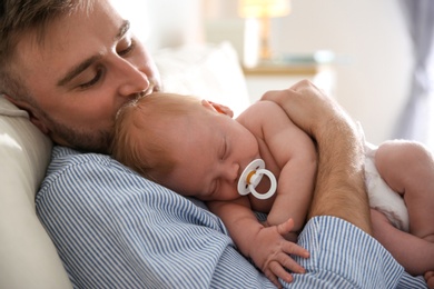 Father with his newborn son at home