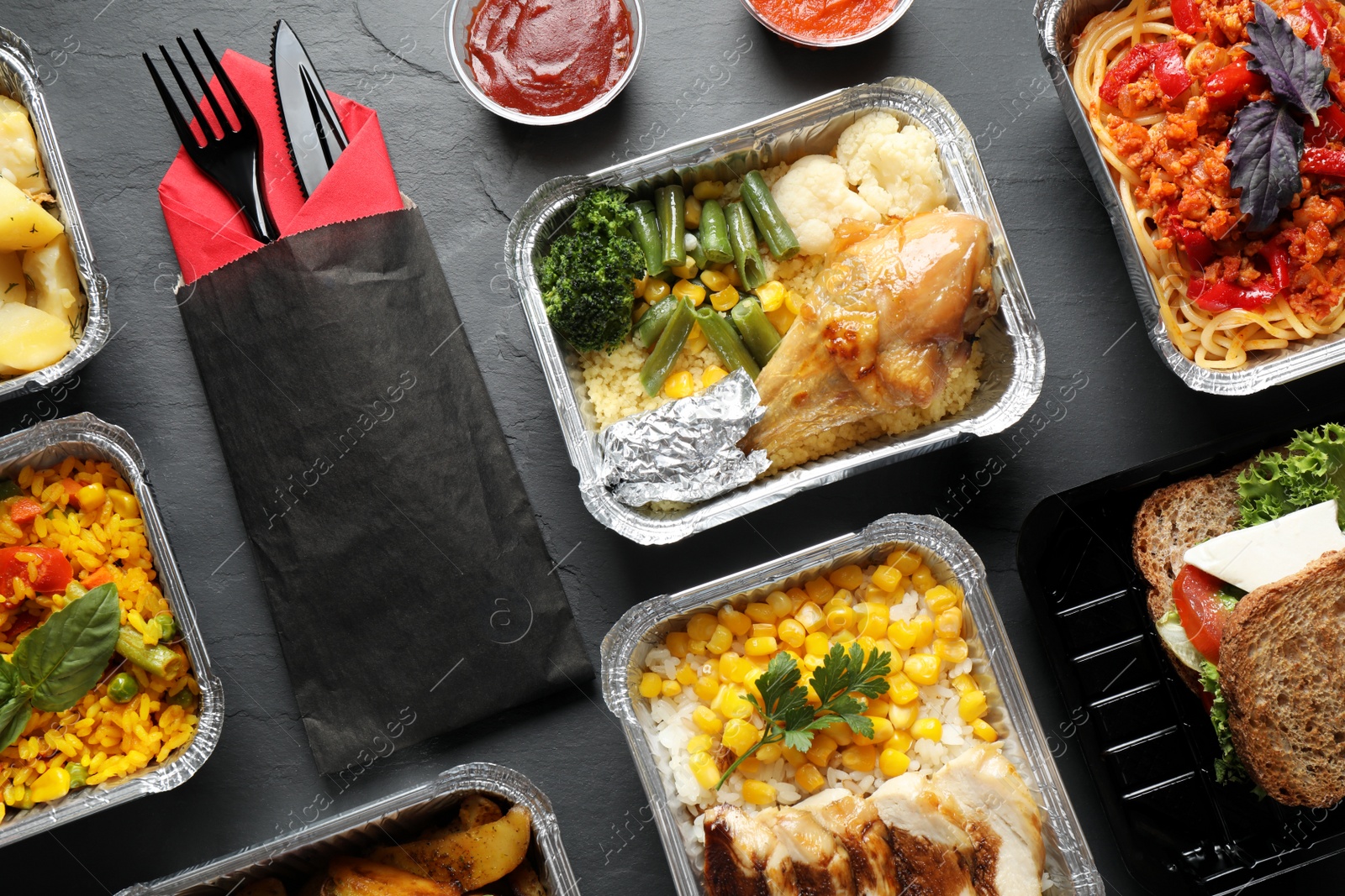 Photo of Lunchboxes on grey table, flat lay. Healthy food delivery