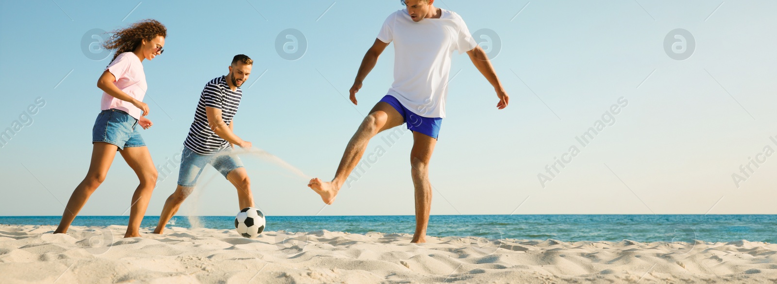 Image of Group of friends playing football on sandy beach, space for text. Banner design