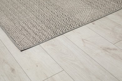 Photo of Soft grey carpet on white laminated floor indoors, space for text