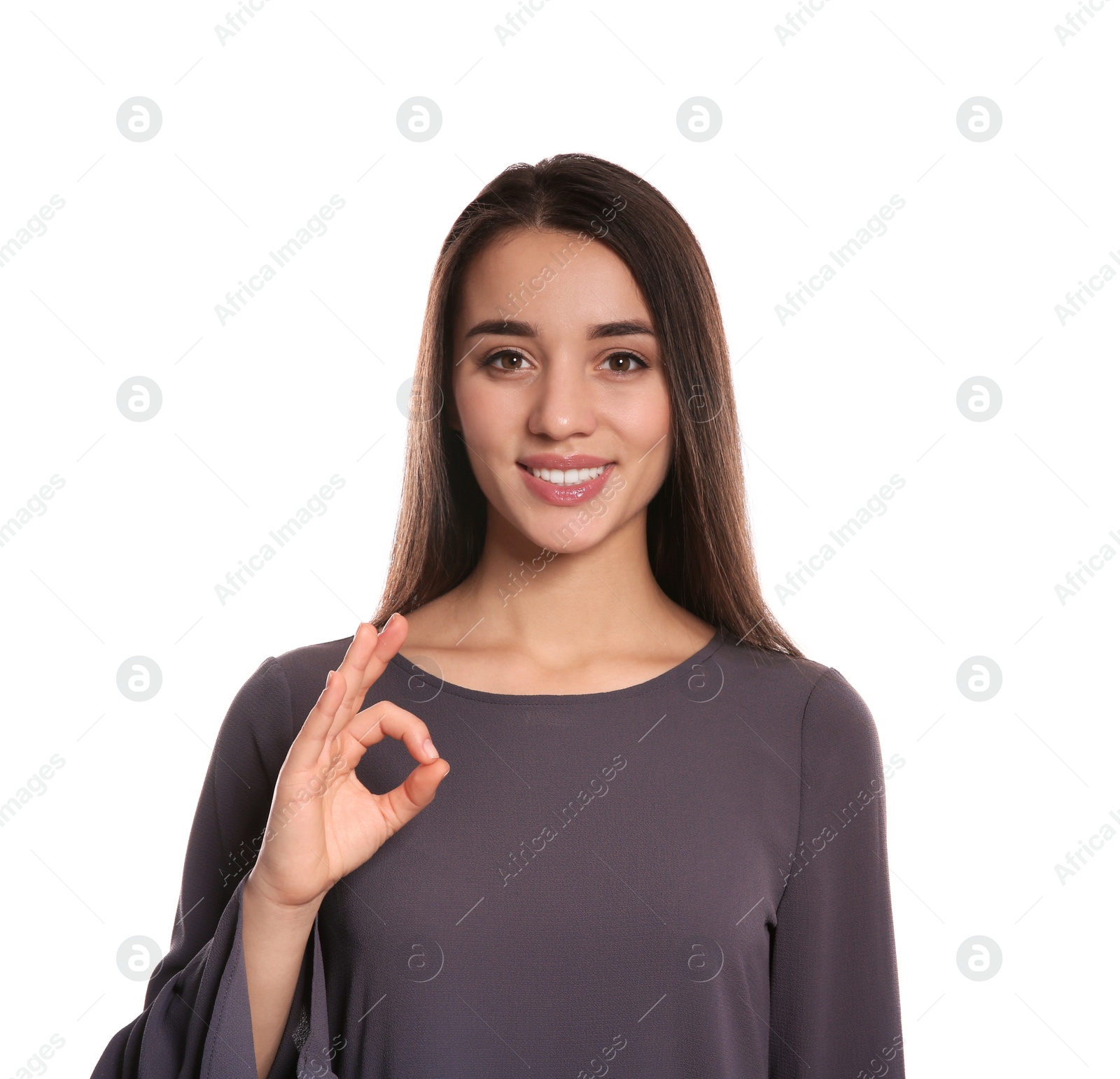 Photo of Woman showing OK gesture in sign language on white background