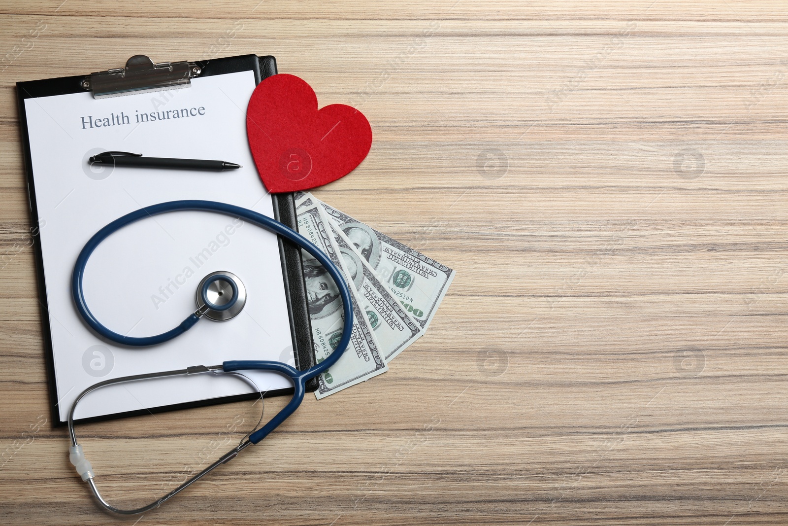 Photo of Flat lay composition with health insurance form and stethoscope on wooden background, space for text