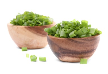 Chopped fresh green onion in bowls isolated on white