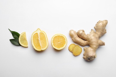 Photo of Fresh lemons and ginger on white background, flat lay