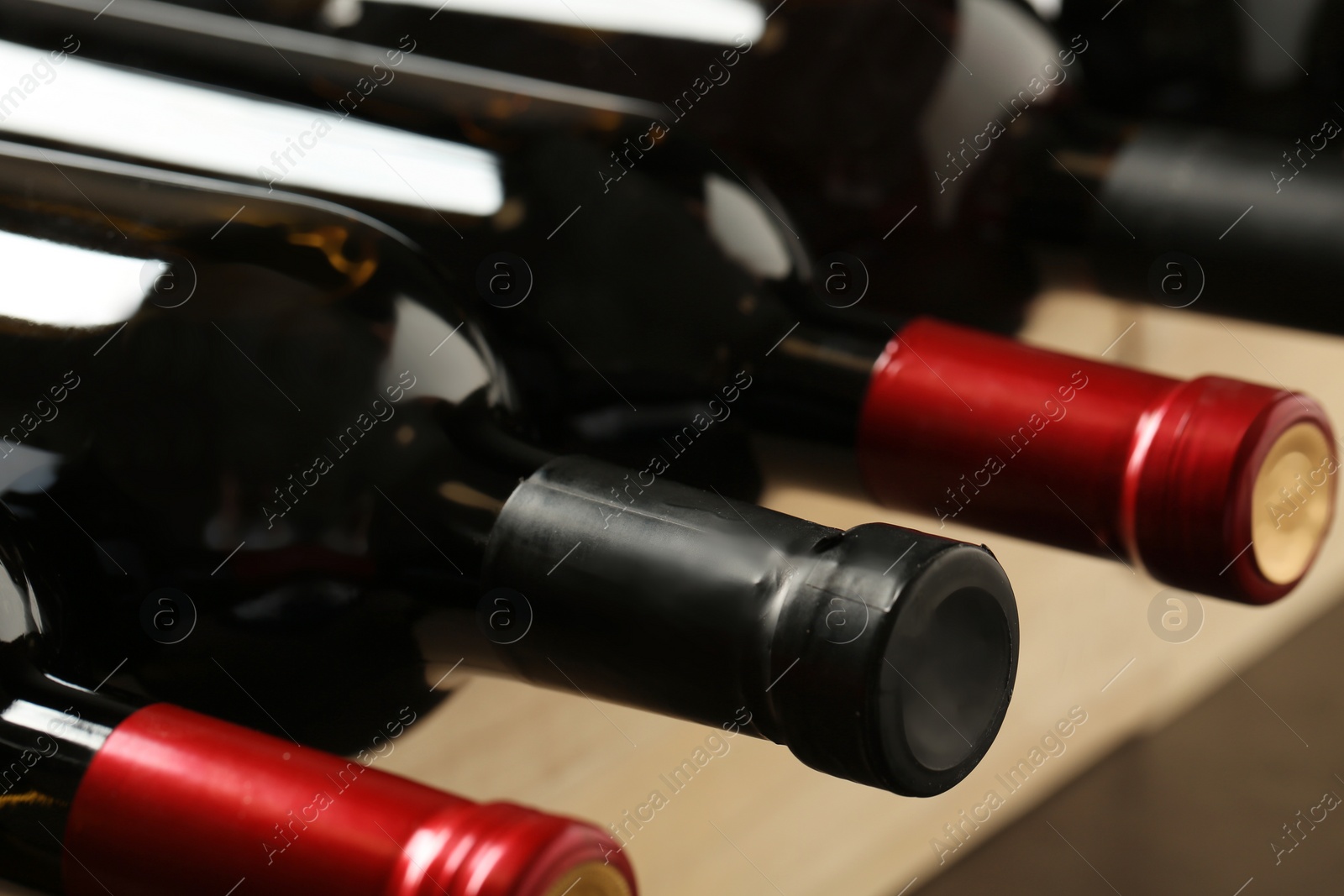 Photo of Bottles of different wines, closeup. Expensive collection