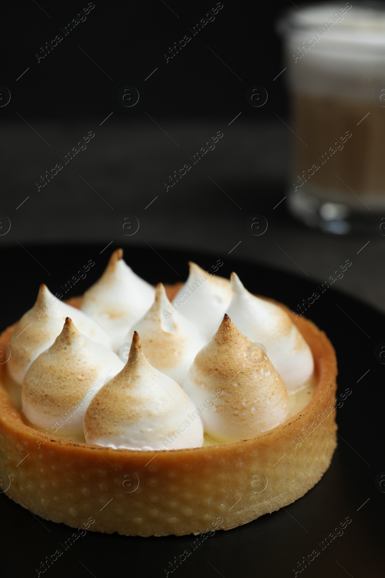 Photo of Tartlet with meringue on table, closeup and space for text. Delicious dessert