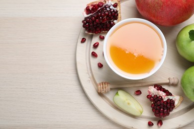 Photo of Honey, pomegranate and apples on wooden table, top view with space for text. Rosh Hashana holiday
