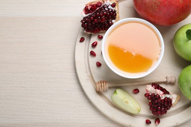 Honey, pomegranate and apples on wooden table, top view with space for text. Rosh Hashana holiday