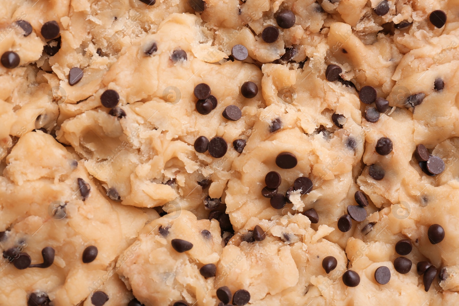 Photo of Cookie dough with chocolate chips as background, closeup