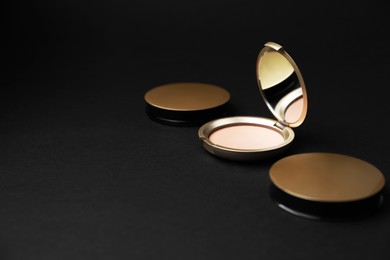 Photo of Face powders on black background, space for text