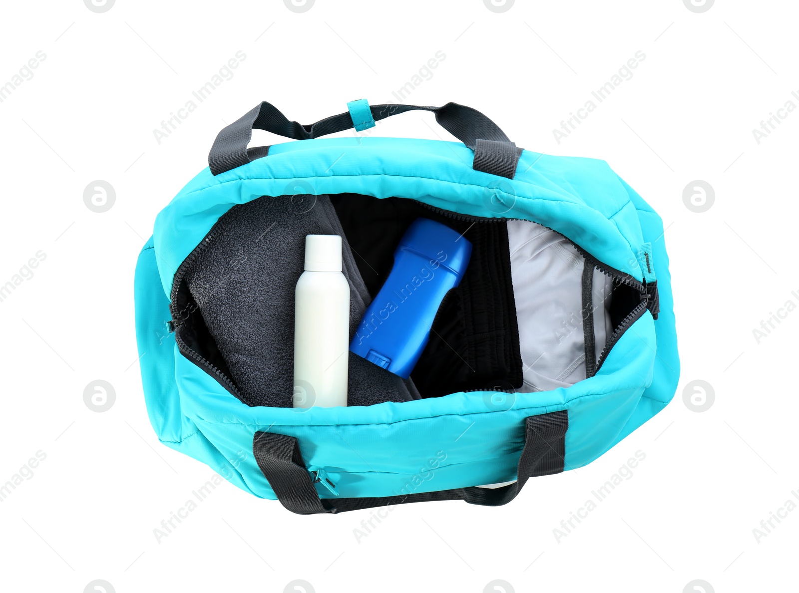 Photo of Sport bag with deodorants and clothes on white background, top view