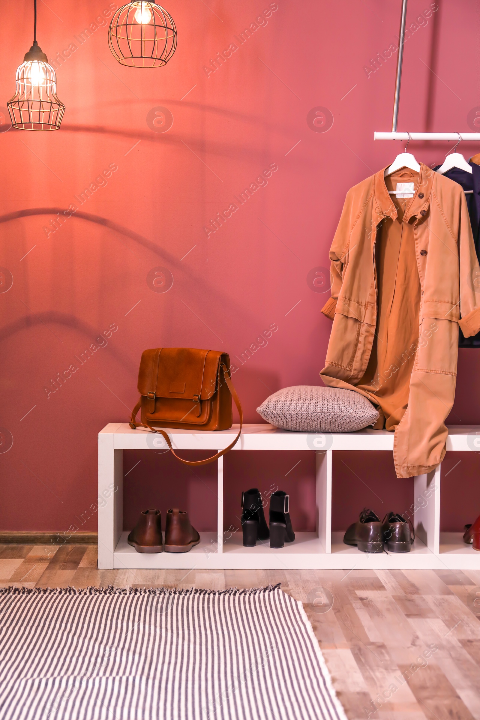 Photo of Modern hallway interior with hanging clothes and shoe rack