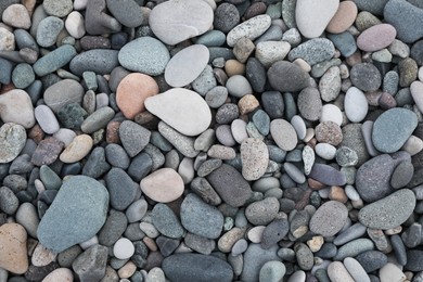 Many different pebbles as background, top view