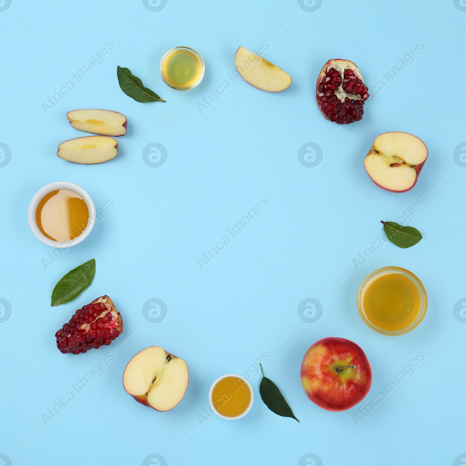 Photo of Flat lay composition with honey and fruits on light blue background, space for text. Rosh Hashanah holiday