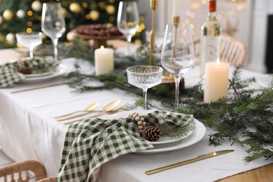 Christmas table setting with festive decor and dishware indoors