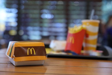 Photo of Lviv, Ukraine - October 9, 2023: Tasty McDonald's burger on wooden table in restaurant