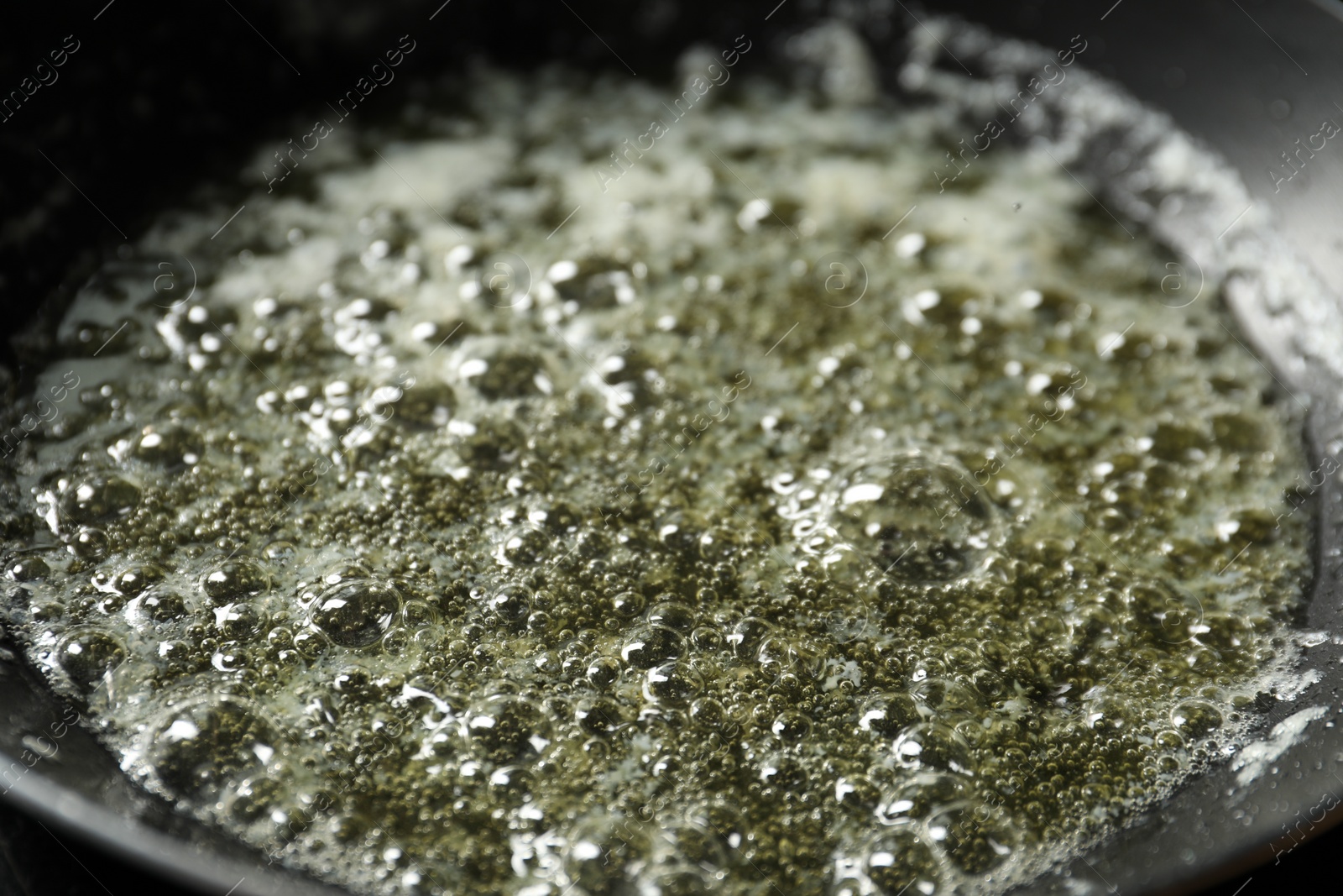 Photo of Melting butter in frying pan, closeup view