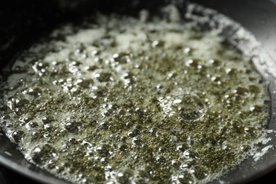 Melting butter in frying pan, closeup view