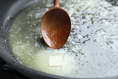 Photo of Melting butter in frying pan, closeup view