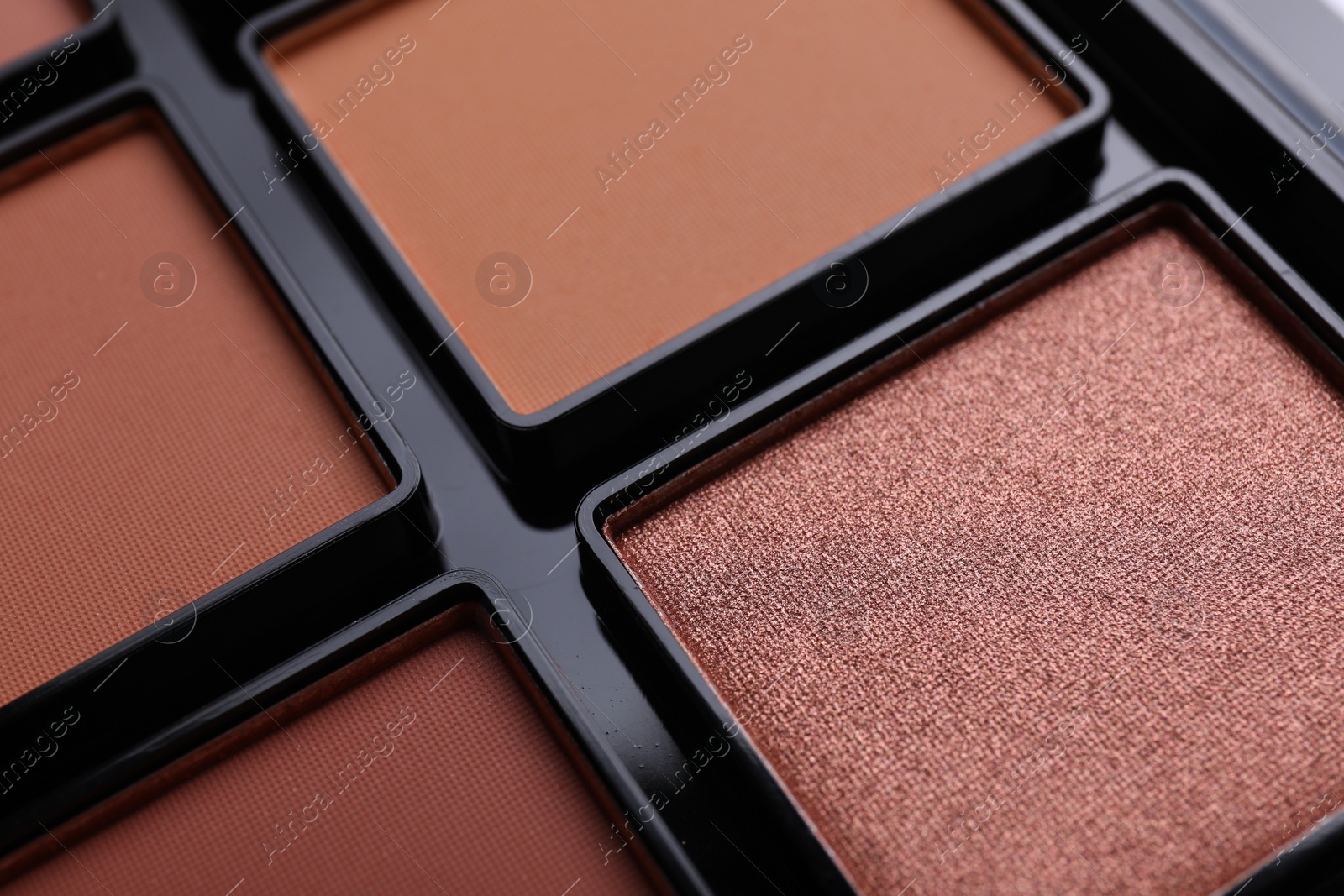 Photo of Colorful contouring palette as background, closeup. Professional cosmetic product