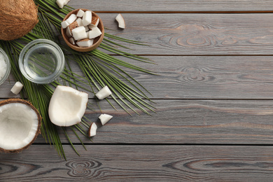 Photo of Flat lay composition with coconut oil on wooden table, space for text