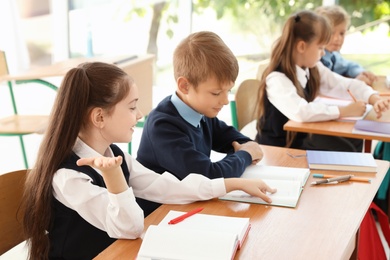 Little children in classroom. Stylish school uniform