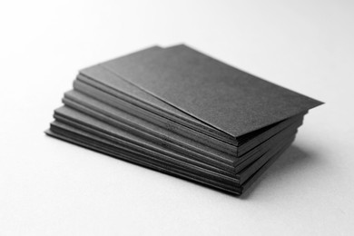 Blank black business cards on white table, closeup