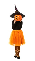 Photo of Cute little girl with pumpkin candy bucket wearing Halloween costume on white background