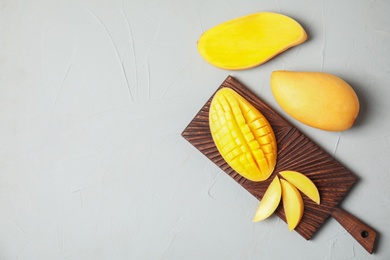 Photo of Flat lay composition with mango on grey background. Space for text