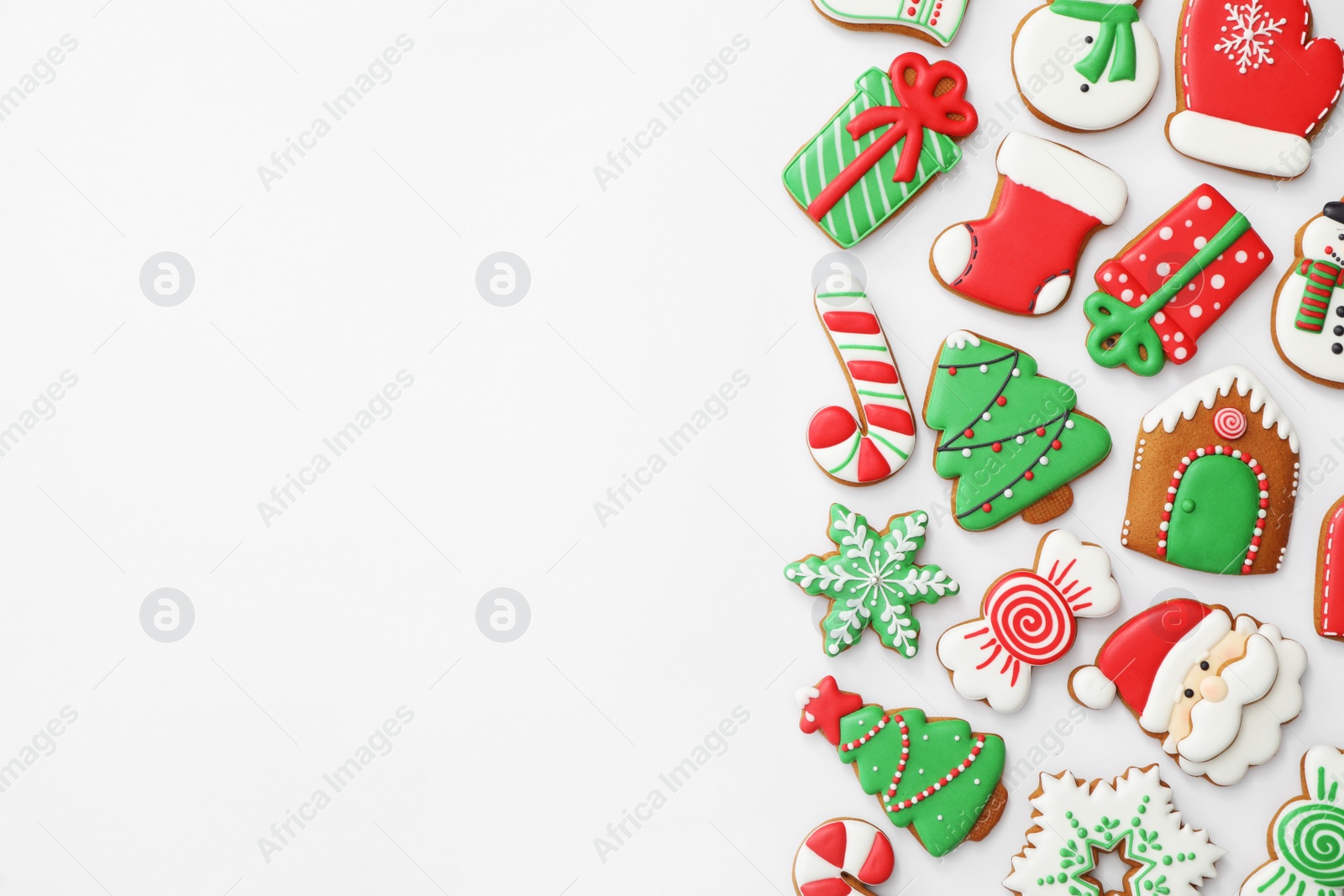 Photo of Different Christmas gingerbread cookies on white background, top view