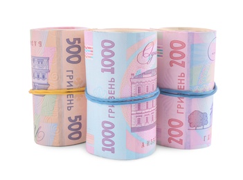 Photo of Rolls of Ukrainian money on white background