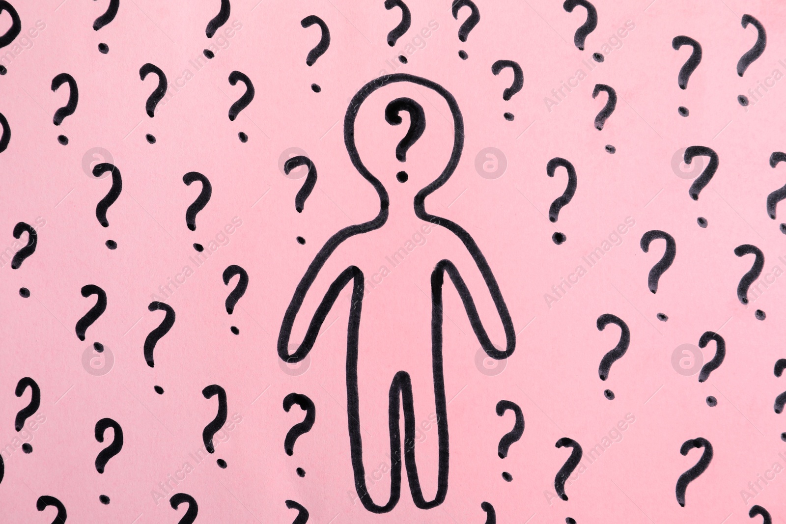 Photo of Picture of human figure and question marks on pink background, top view
