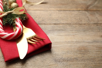 Cutlery set and festive decor on wooden table, closeup with space for text. Christmas celebration