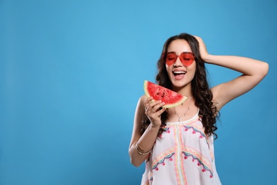 Photo of Beautiful young woman with watermelon on blue background. Space for text