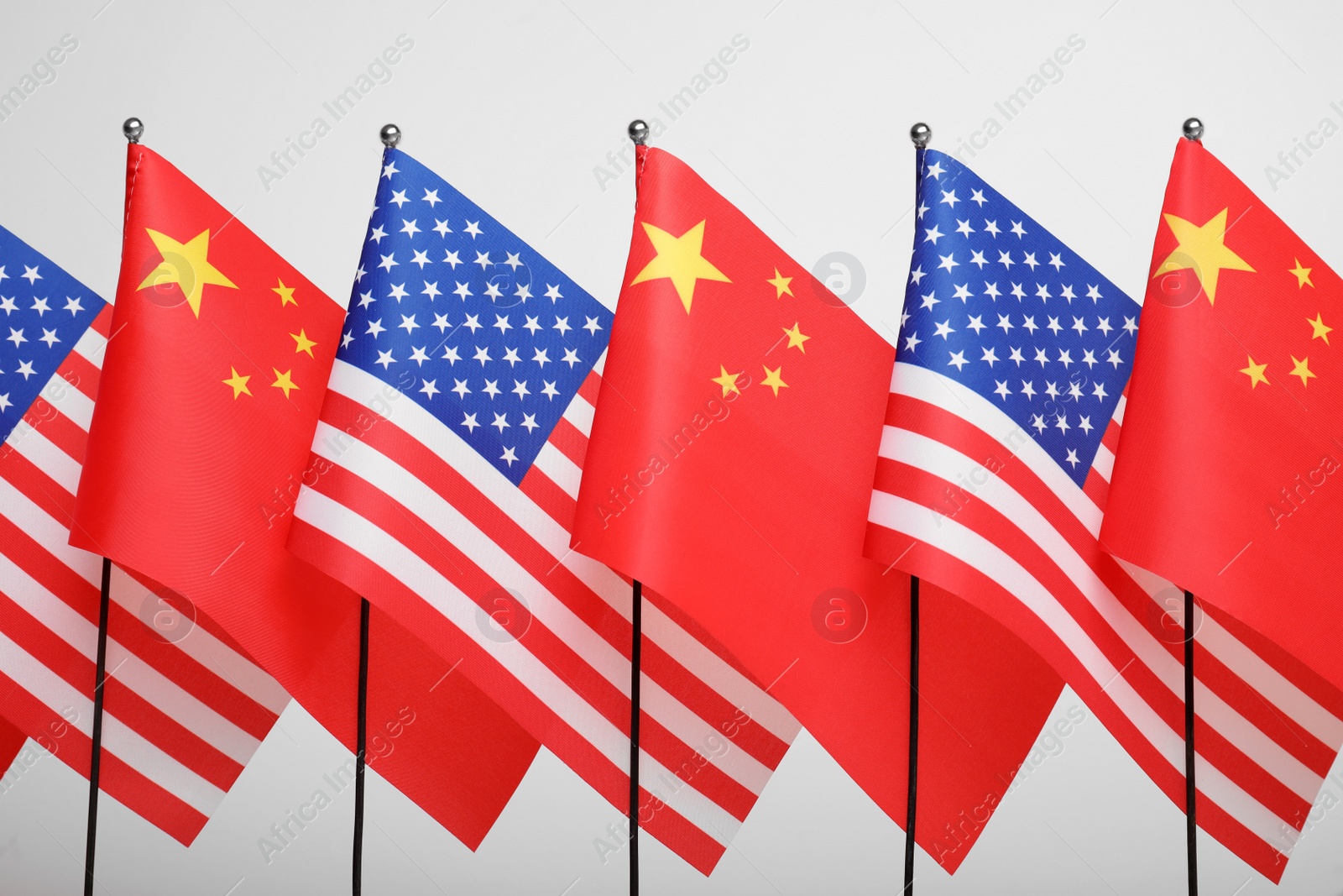 Photo of USA and China flags on white background. International relations