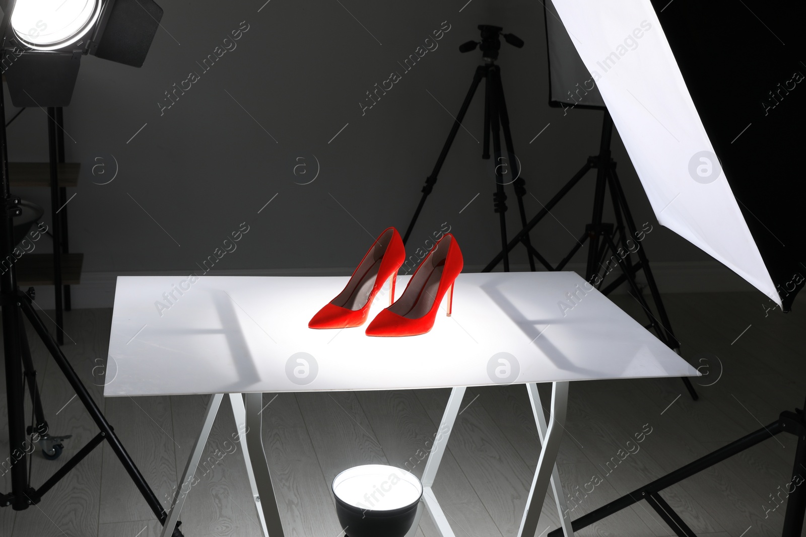 Photo of Professional photography equipment prepared for shooting stylish shoes in studio