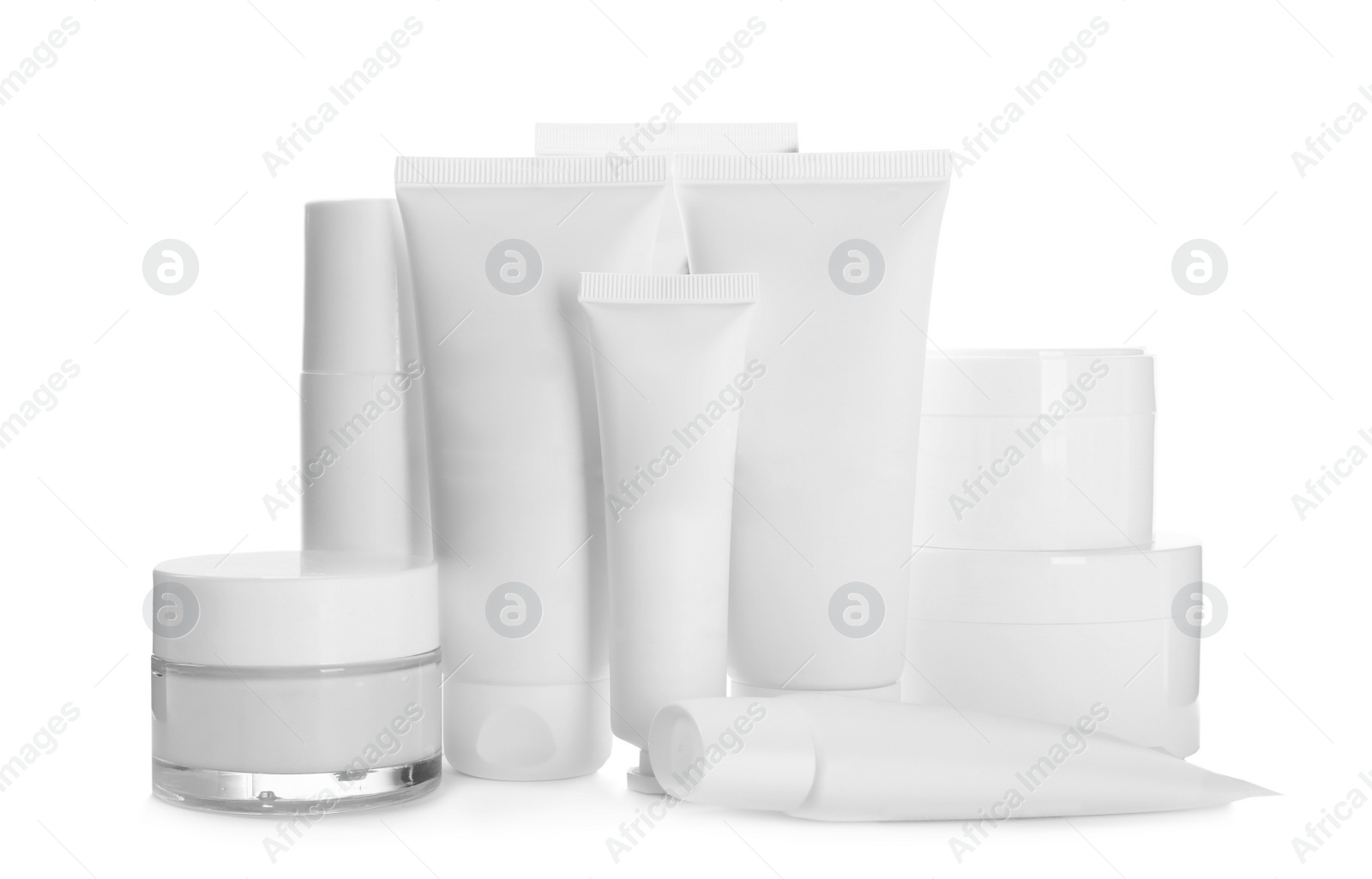 Photo of Blank tubes and jars of cosmetic products on white background