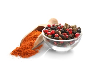 Photo of Scoop and bowl with different types of pepper on white background